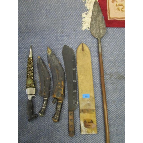 209 - An Asian machete in leather scabbard, two kukris in scabbards, an Indian knife with horse's head han... 