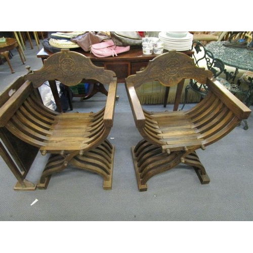 214 - A pair of mid 20th century Savanarola elm finished chairs with carved backs and crossover frames