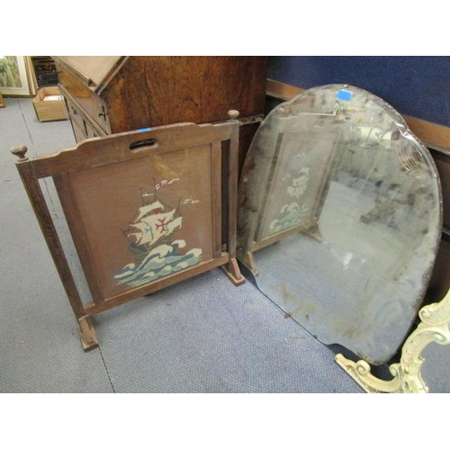 215 - A 1930s shield shaped mirror and a 1930s oak firescreen