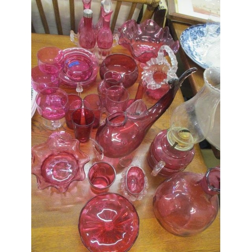 238 - A collection of early to mid 20th century cranberry glassware to include an oil lamp