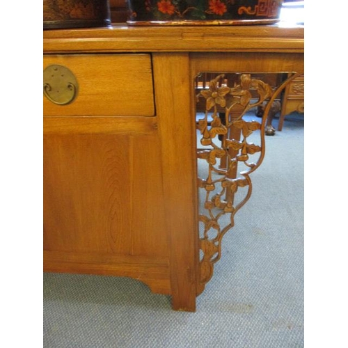 244 - A Chinese oak scroll desk with three short drawers and cupboards below flanked by pierced floral bra... 