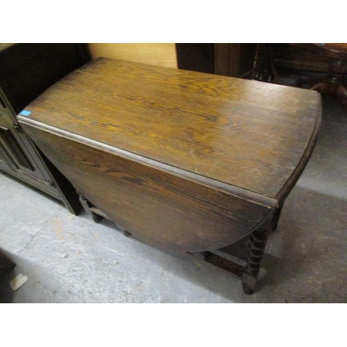 285 - A 1930s oak drop leaf dining table on barley twist legs, and a mid 20th century oak Dutch style dres... 