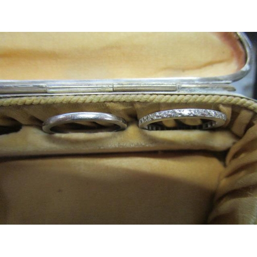 313 - A white metal diamond full eternity ring, along with a white metal (possibly platinum) wedding band,... 