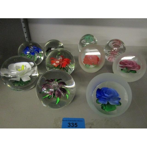 335 - A group of assorted glass paperweights to include Chinese flower weights