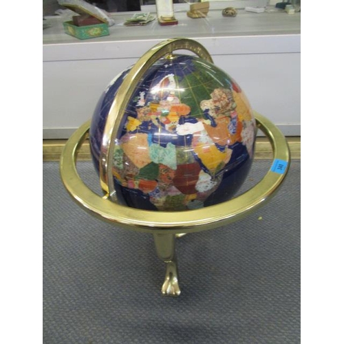 340 - An inlaid hardstone globe in a brass framed stand