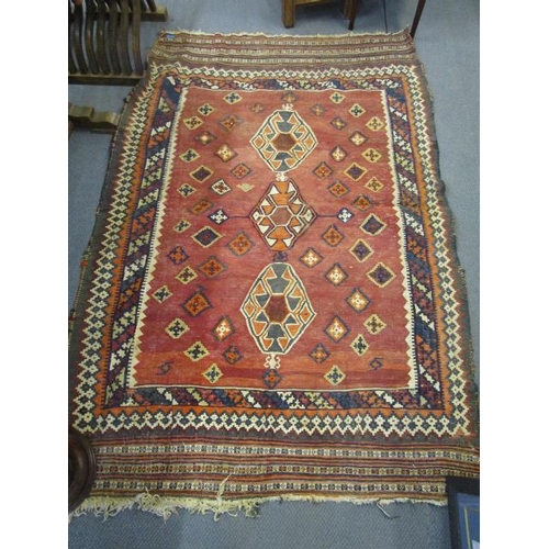 346 - An early to mid 20th century Kelim handwoven rug with geometric devices on a pale red ground with mu... 