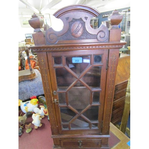 352 - A late Victorian/Edwardian table display cabinet with carved pediment, flanked by turned finials, ab... 