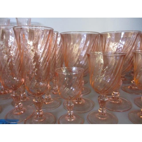 378 - A quantity of pink drinking glasses to include twelve wine, twelve champagne flutes, sixteen champag... 