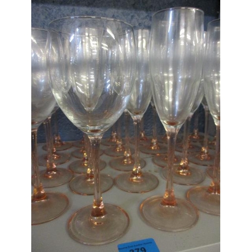 379 - A quantity of pink stemmed champagne flutes and wine glasses