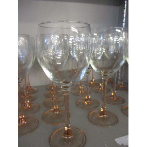 380 - A quantity of pink stemmed cocktail and wine glasses