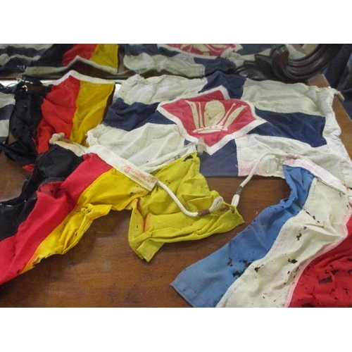 391 - A selection of vintage cloth flags A/F to include two German flags retailed by Captain O M Watts Ltd... 