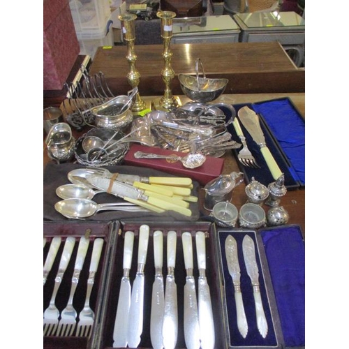 172 - A pair of brass candlesticks and mixed silver plate to include grape scissors and a toast rack