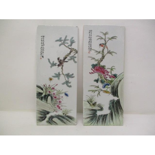 413 - A pair of 20th century Chinese plaques, each decorated with birds on a branch, above rocks and flowe... 