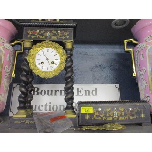 223 - LeRoy A Paris ebonized an inlaid barley twist cased mantle clock on stand, with pendulum and key