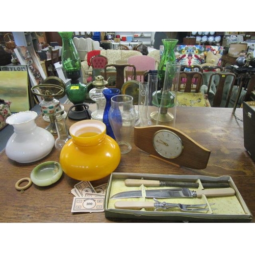 247 - A selection of oil lamps, shades and accessories, along with a Tempora mantel clock and a boxed carv... 