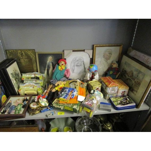 250 - A mixed lot of framed and glazed prints, childrens' books, puppets, tins and other toys