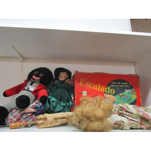 237 - A selection of dolls to include a Golly, together with a boxed Escalado game