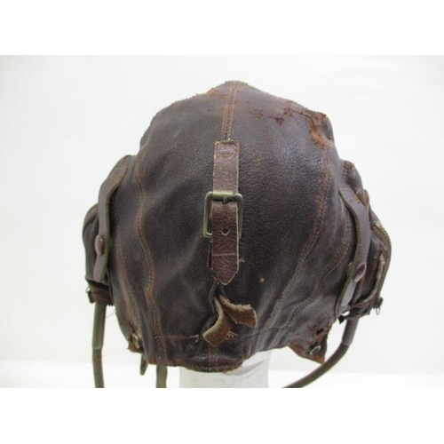 148 - A WWII brown leather flying helmet with earphones, inscribed Ref NO 6F/154 AM