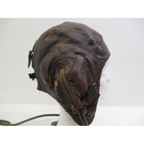 148 - A WWII brown leather flying helmet with earphones, inscribed Ref NO 6F/154 AM