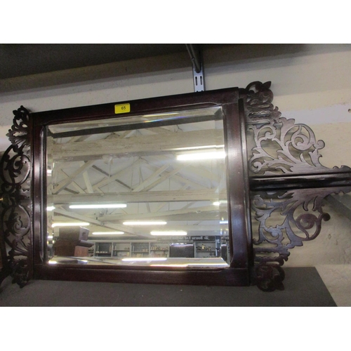 65 - A mid 20th century mahogany mirror with fretwork to the frame and shelf below, together with an earl... 