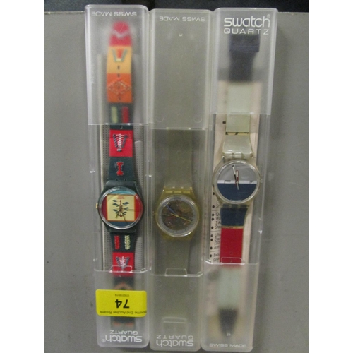 74 - Three cased Swatch watches