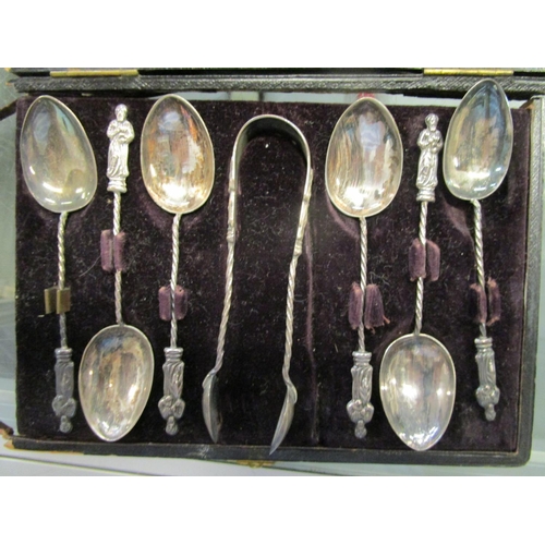 75 - A cased set of six silver apostle coffee spoons with matching sugar tongs, Birmingham hallmarks