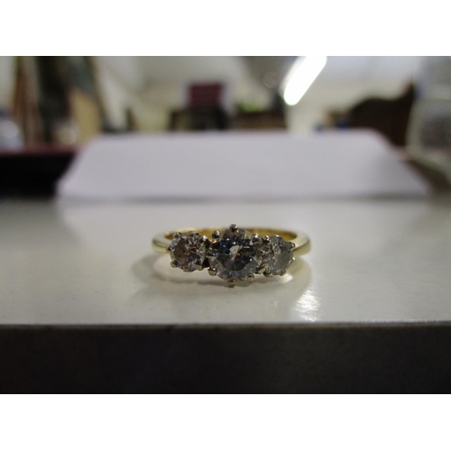 88 - An 18ct yellow gold and three-stone diamond ring, total weight 3.9g