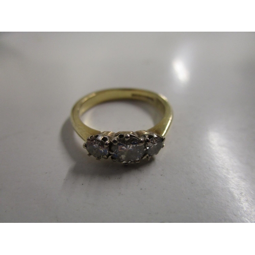 88 - An 18ct yellow gold and three-stone diamond ring, total weight 3.9g