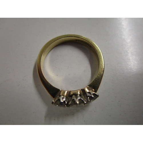 88 - An 18ct yellow gold and three-stone diamond ring, total weight 3.9g