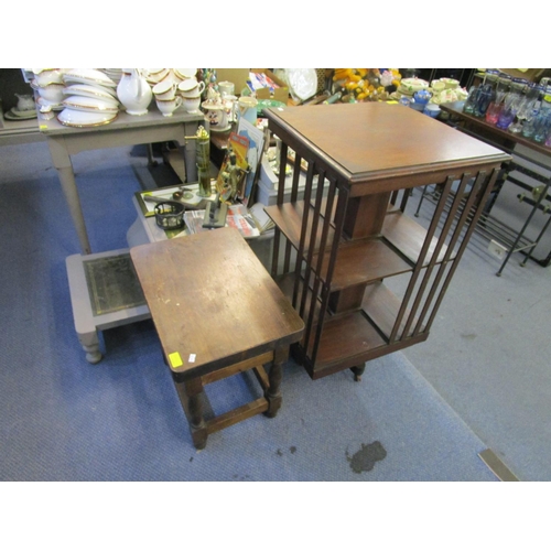 496 - An Edwardian mahogany revolving bookcase, together with a reproduction lamp table with a single draw... 