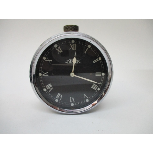 63 - A Jaeger vintage car clock converted to a bedside clock, having a black dial with Roman numerals and... 