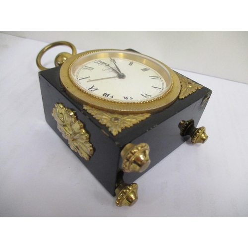 73 - An Asprey of London 20th century miniature carriage alarm clock, having a black case with gilt ormol... 