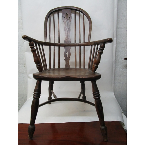 179 - A 19th century ash and elm Windsor chair with a pierced, splat, level arms and moulded seat, on ring... 