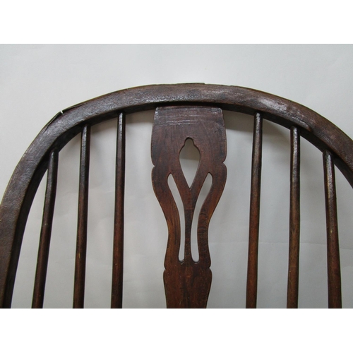 179 - A 19th century ash and elm Windsor chair with a pierced, splat, level arms and moulded seat, on ring... 