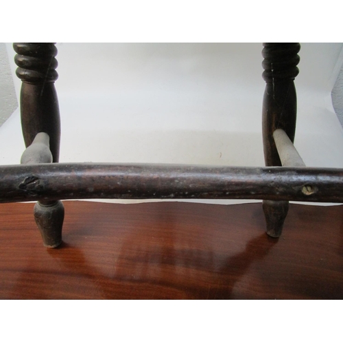 179 - A 19th century ash and elm Windsor chair with a pierced, splat, level arms and moulded seat, on ring... 