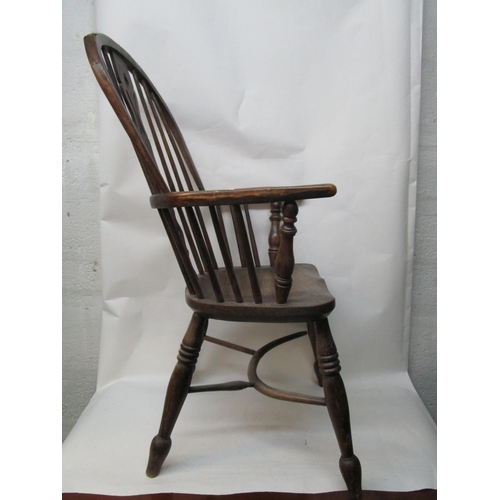 179 - A 19th century ash and elm Windsor chair with a pierced, splat, level arms and moulded seat, on ring... 