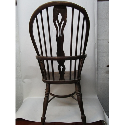 179 - A 19th century ash and elm Windsor chair with a pierced, splat, level arms and moulded seat, on ring... 