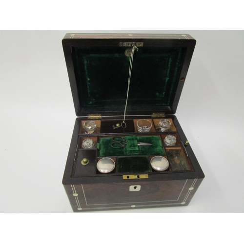364 - A Victorian mother of pearl inlaid rosewood vanity case with a hinged lid, enclosing a green leather... 