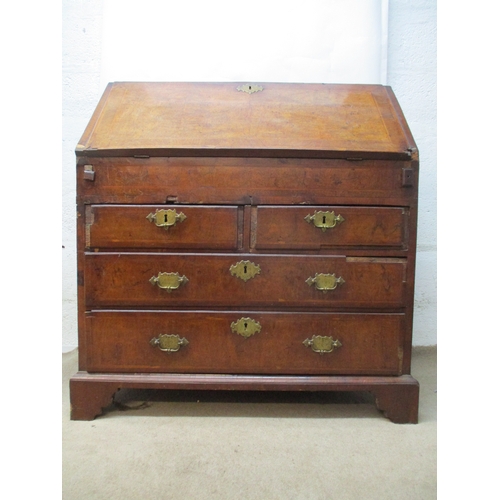 366 - An early 18th century walnut bureau with a feather and crossbanded fall flap enclosing a well, pigeo... 