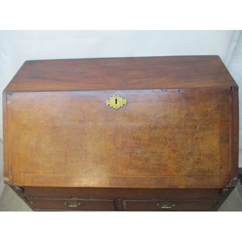 366 - An early 18th century walnut bureau with a feather and crossbanded fall flap enclosing a well, pigeo... 
