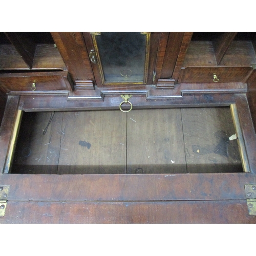 366 - An early 18th century walnut bureau with a feather and crossbanded fall flap enclosing a well, pigeo... 