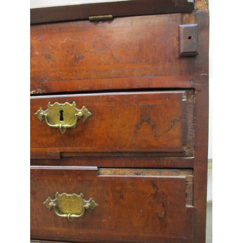 366 - An early 18th century walnut bureau with a feather and crossbanded fall flap enclosing a well, pigeo... 
