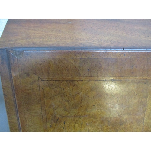 366 - An early 18th century walnut bureau with a feather and crossbanded fall flap enclosing a well, pigeo... 