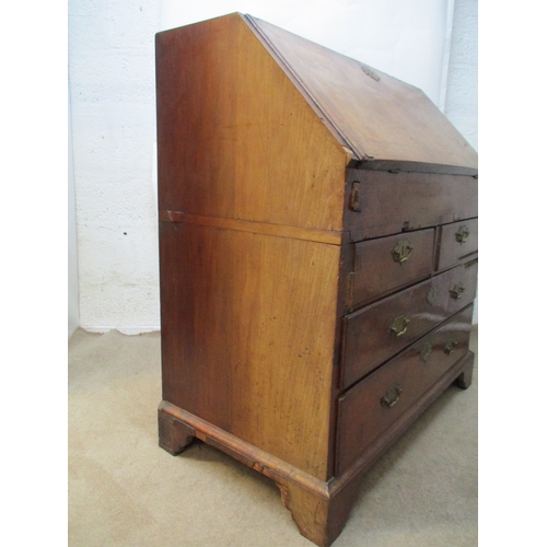 366 - An early 18th century walnut bureau with a feather and crossbanded fall flap enclosing a well, pigeo... 