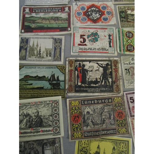 103 - A quantity of Russian and German emergency currency from the 1920s to include those with designs, al... 