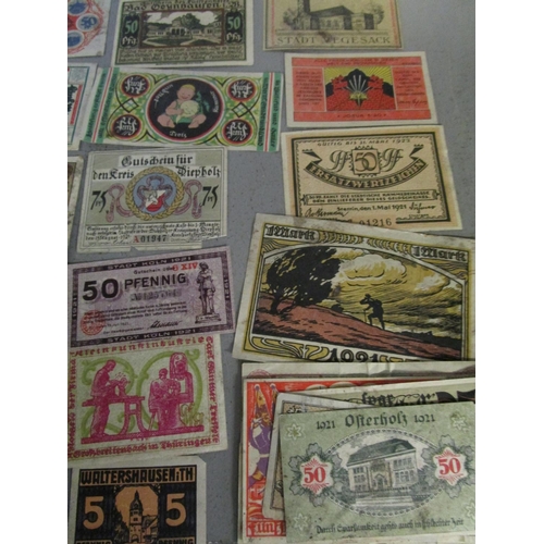 103 - A quantity of Russian and German emergency currency from the 1920s to include those with designs, al... 