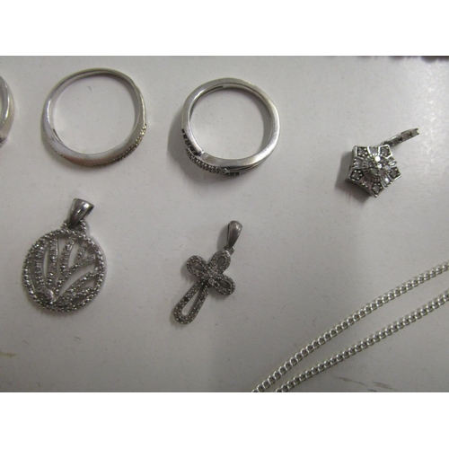 127 - A group of silver set and diamond pendants, silver and diamond set rings, a silver cross set with re... 