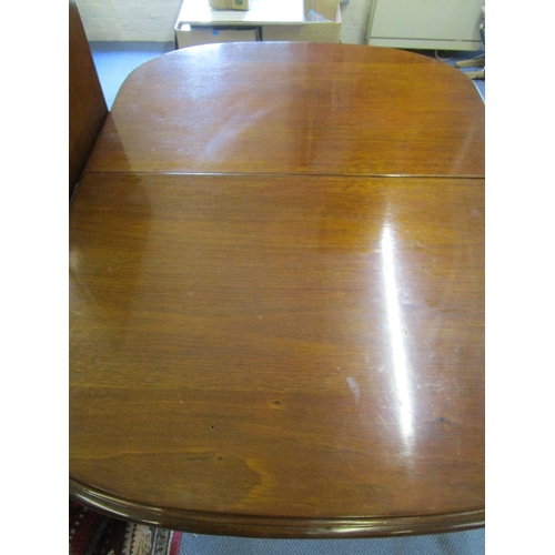 130 - A Victorian mahogany wind-out dining table on turned legs and castors, with one extra leaf 28