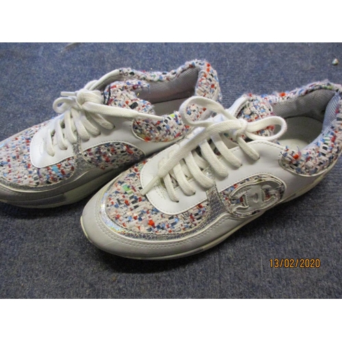 145 - A pair of trainers in the style of a French fashion house, having multi-coloured boucle fabric and s... 