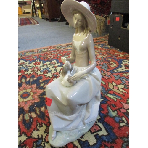 259 - A large Lladro figure of a young lady petting her Pekinese dog. 
Location: FSR